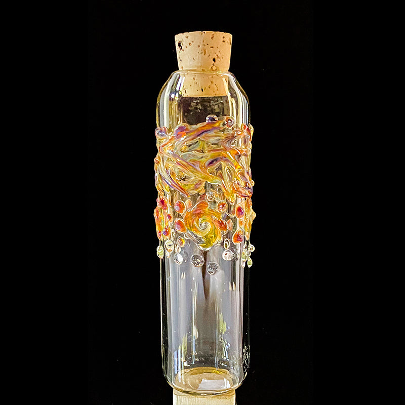 glass jar with orange and red swirls and dots
