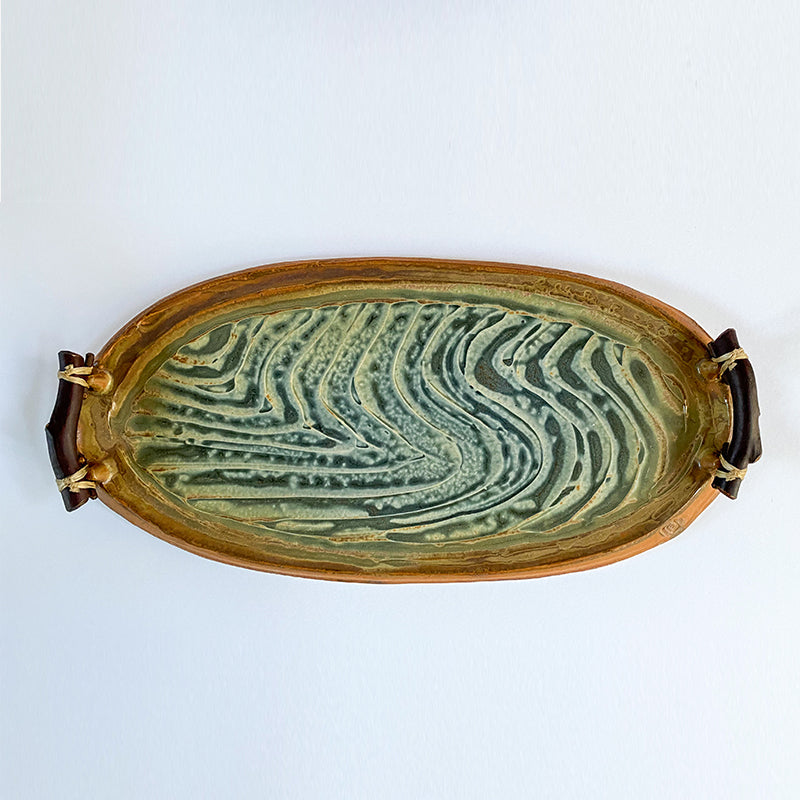 blue, tan and white tray with lines and swirls