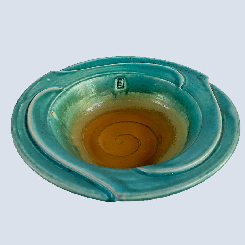 teal and tan bowl with swirls