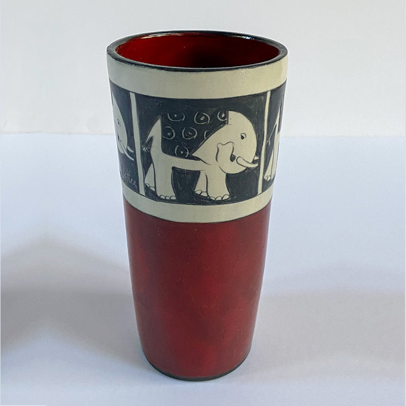 red, white and black ceramic cup with elephant